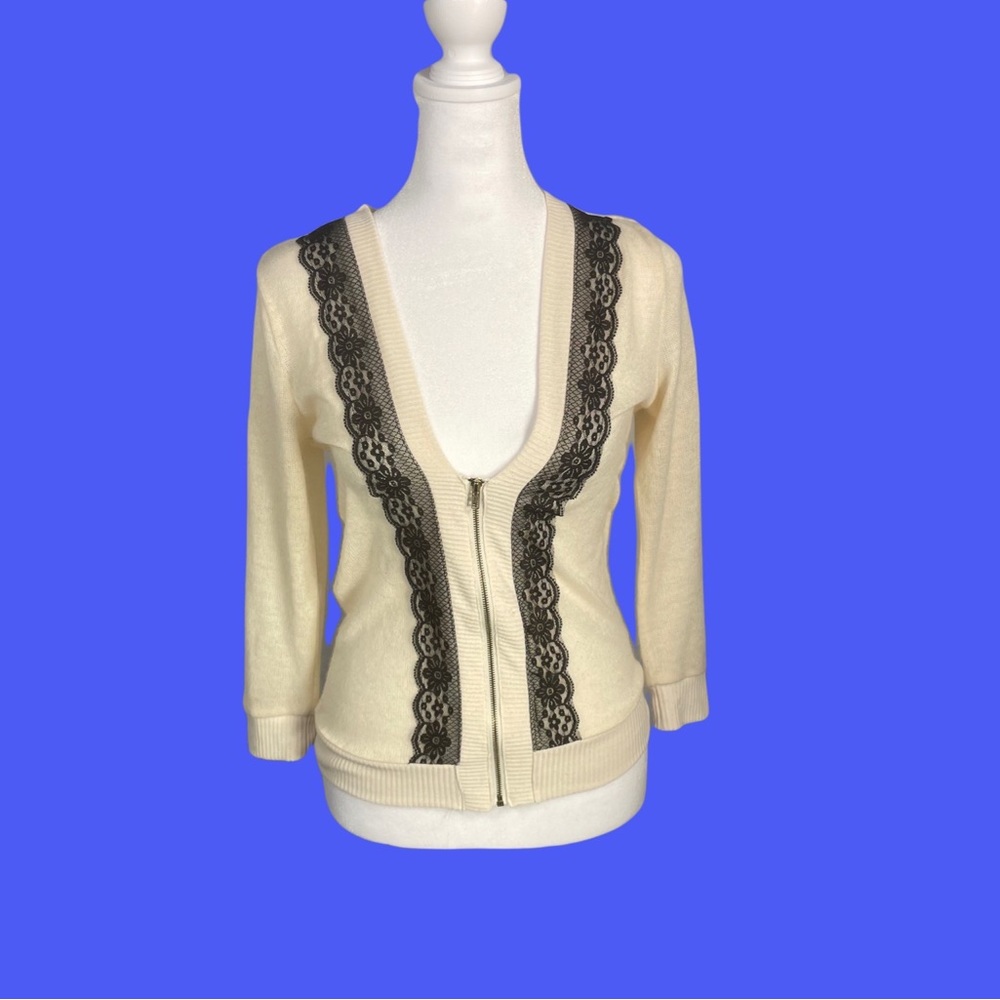 Elegant cream Carthaginian with black lace detailing on front.
